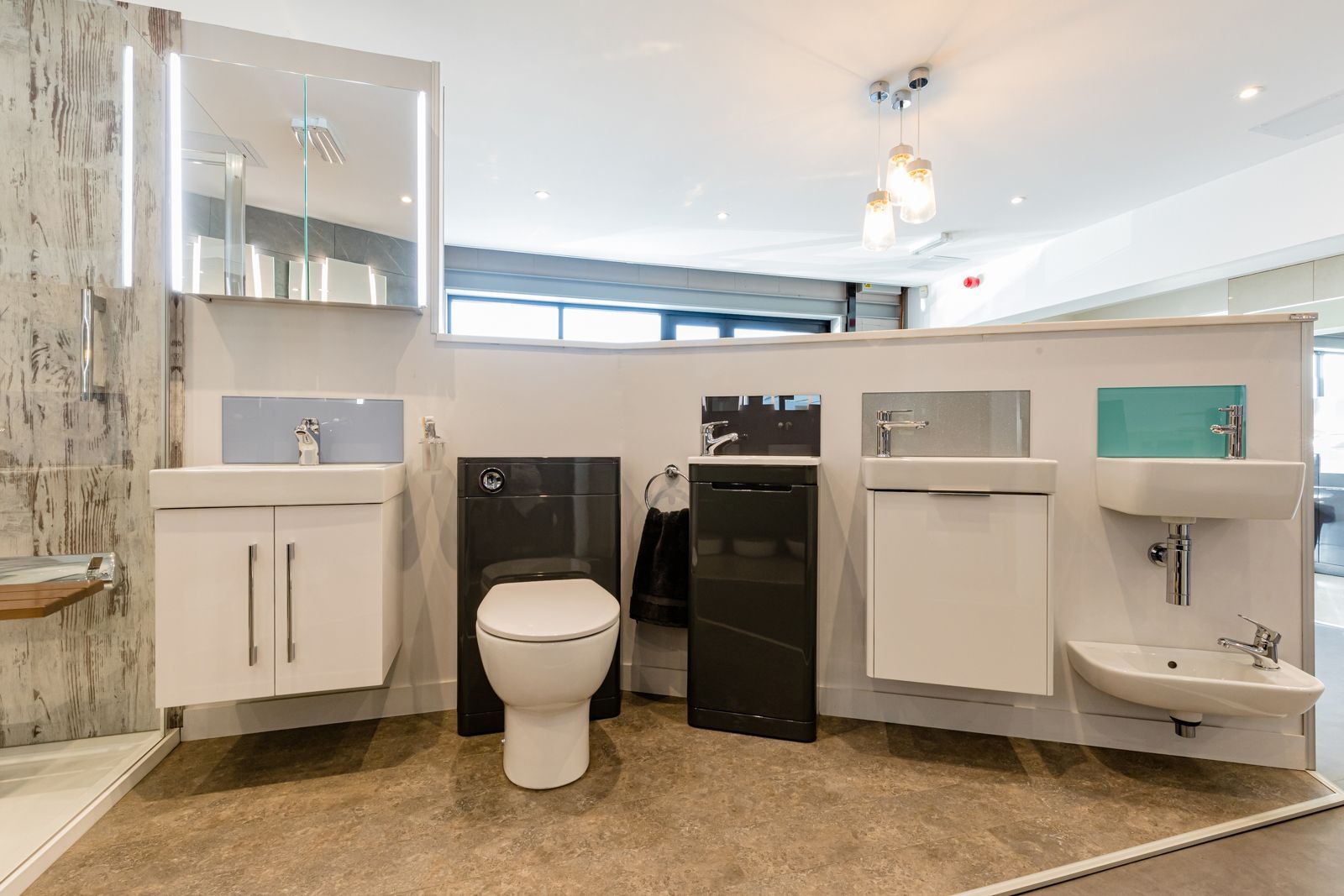 A bathroom with a toilet , sink and mirror.