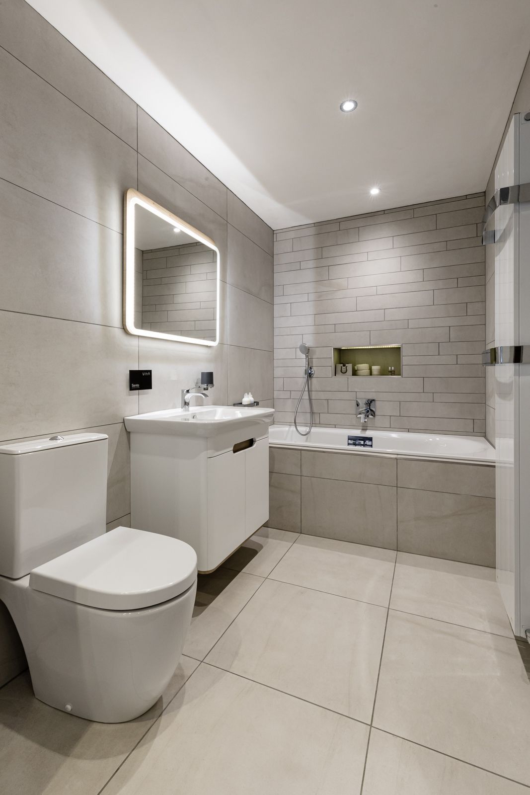 A bathroom with a toilet , sink , and bathtub.