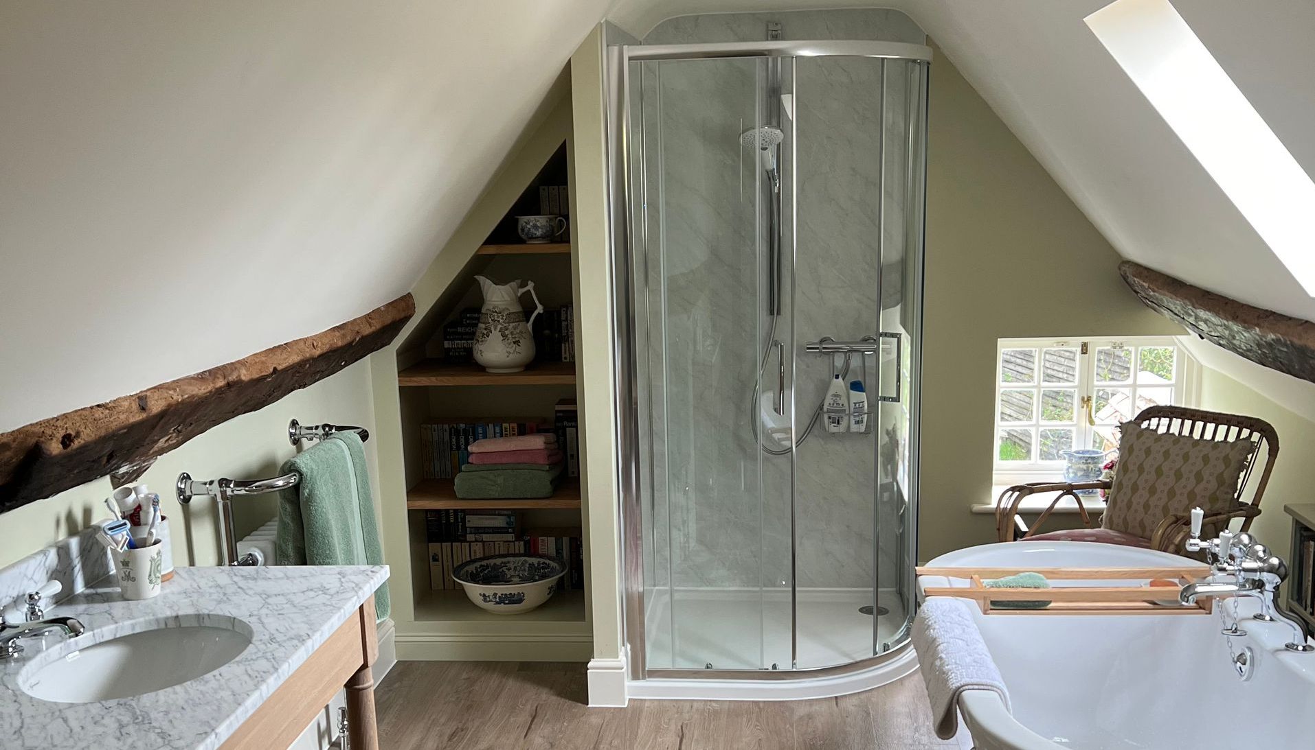 A bathroom with a bathtub , sink , and shower.