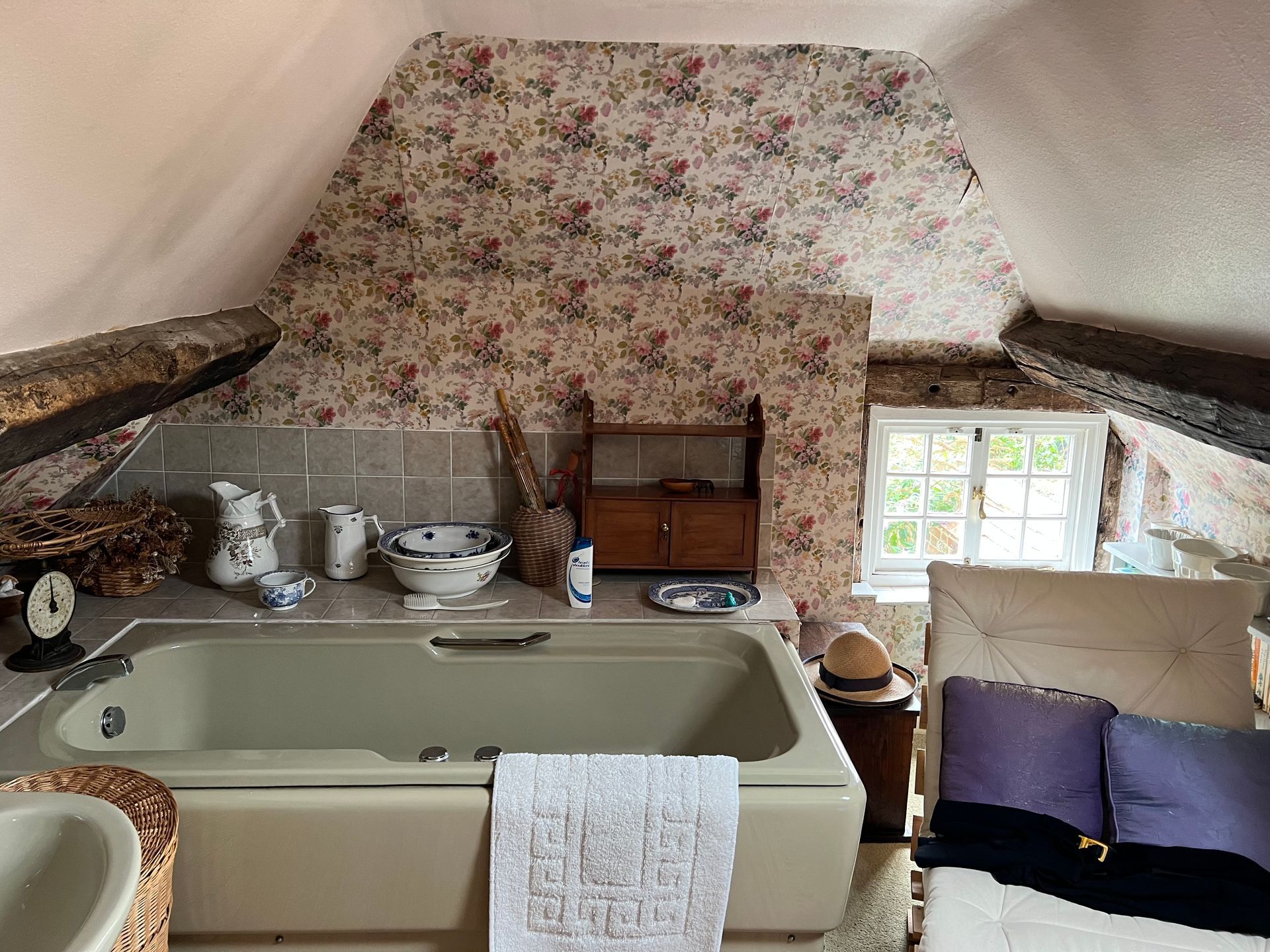 A bathroom with a bathtub and a bed in it