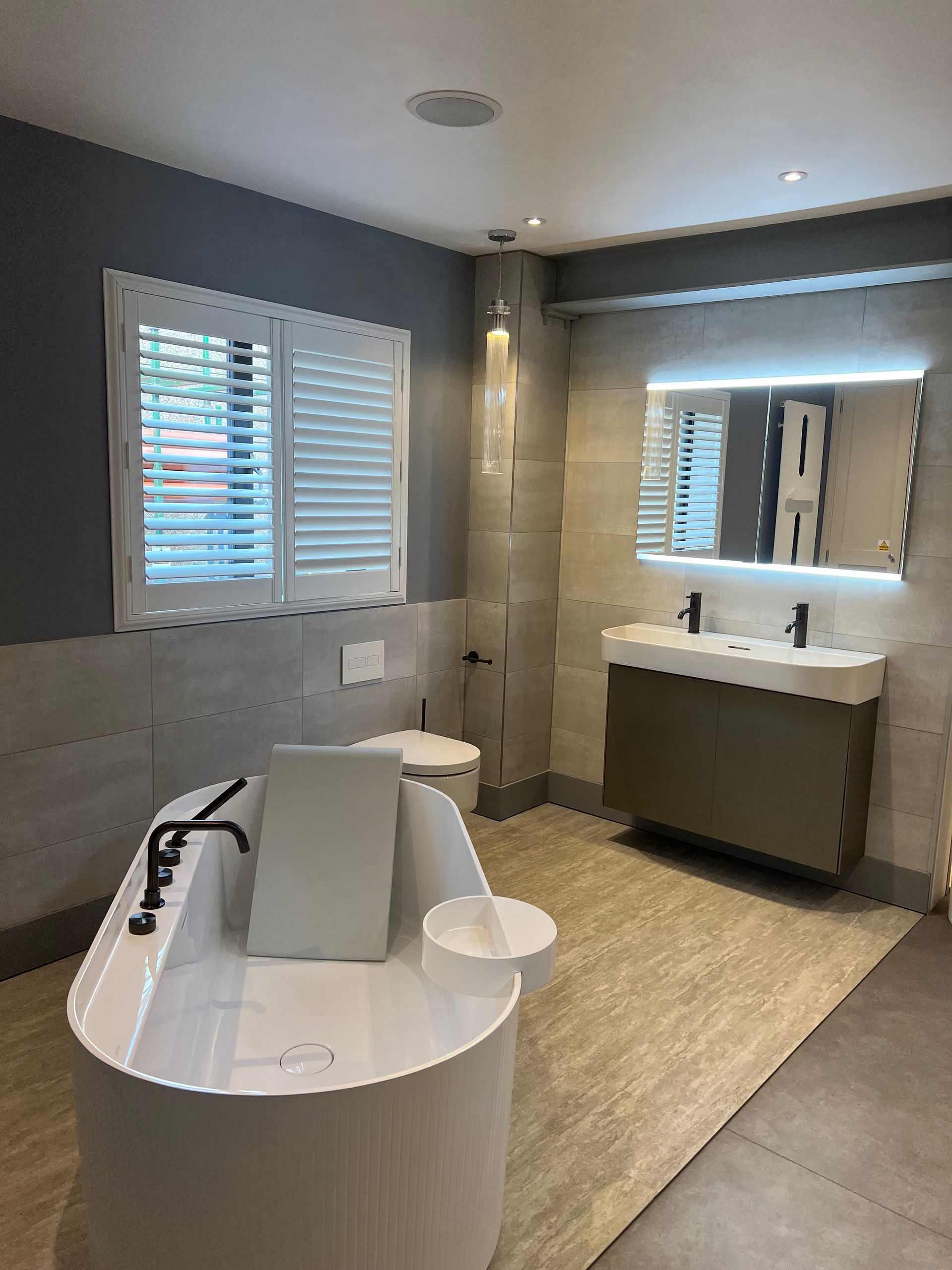 A bathroom with a bathtub , toilet , sink and mirror.