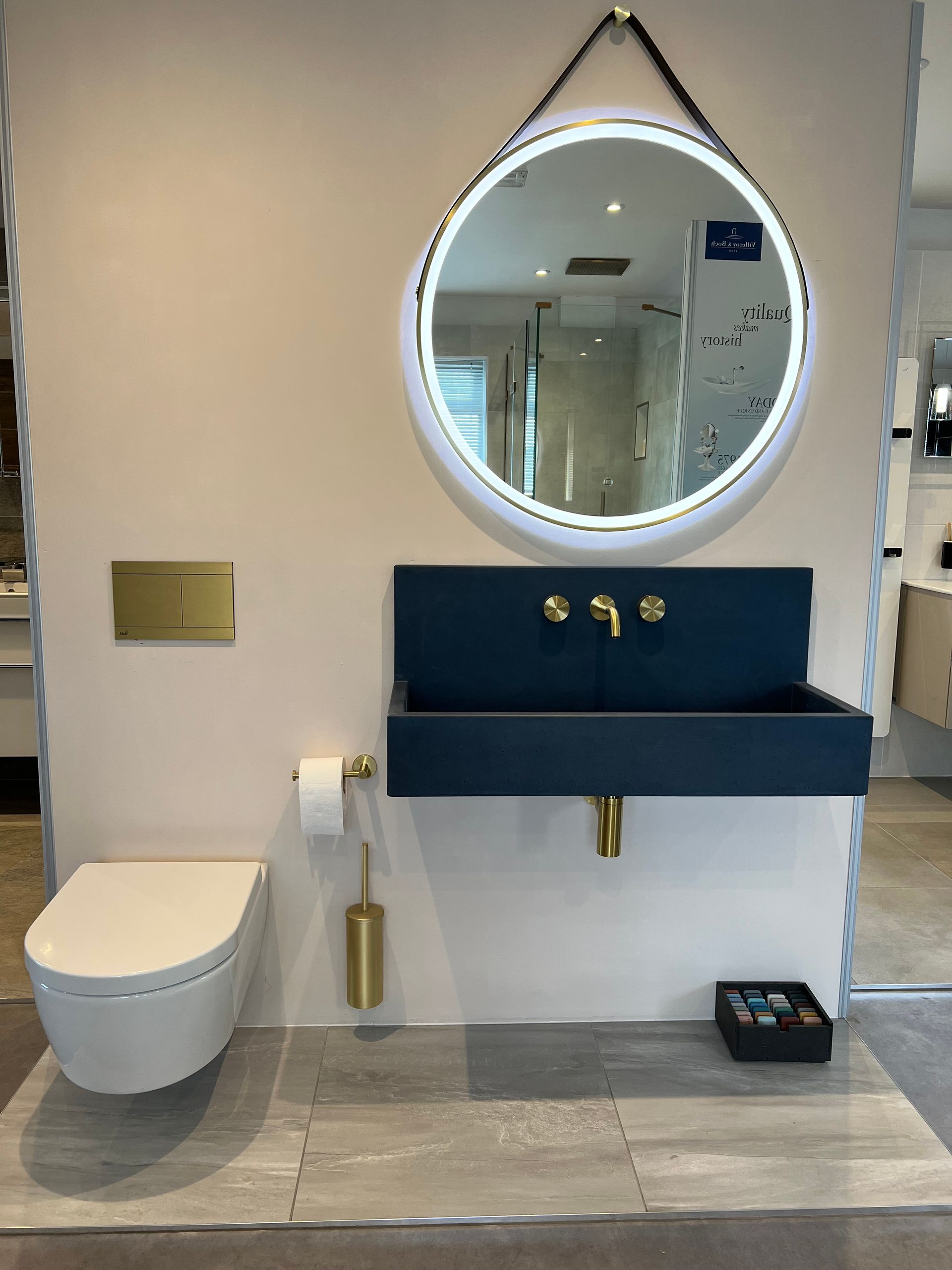 A bathroom with a toilet a sink and a mirror