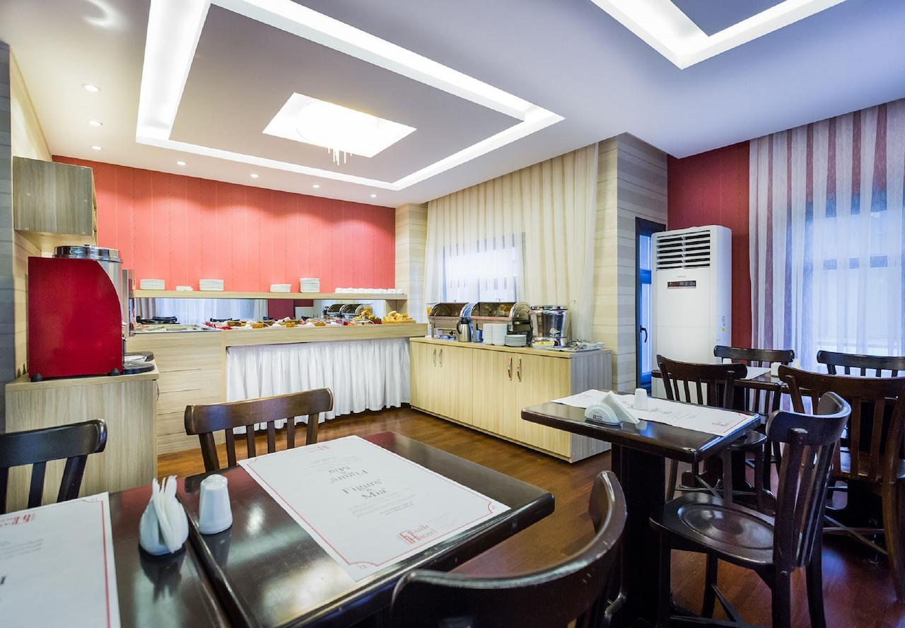A restaurant with tables and chairs and a buffet