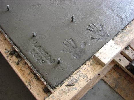 Concrete slab with a child's hand prints labeled Laredo 2009