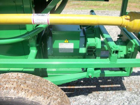 A green machine with a yellow pipe attached to it