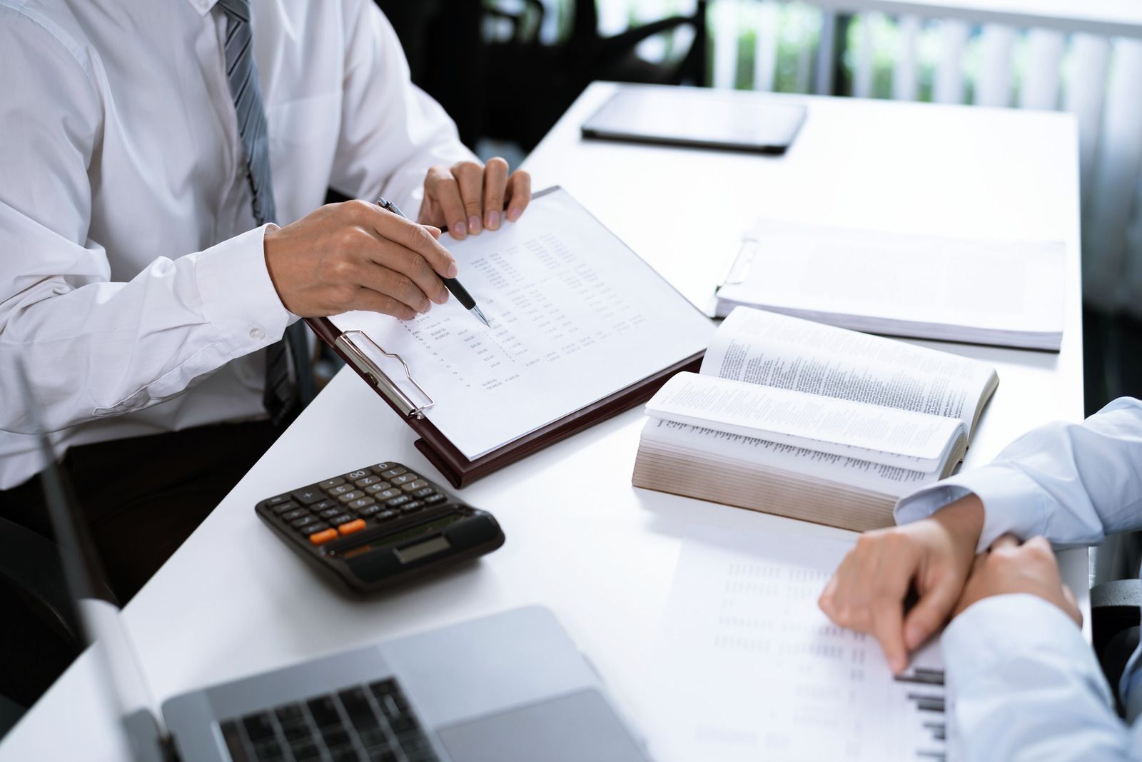 A hand holds a wooden cutout of an umbrella labeled