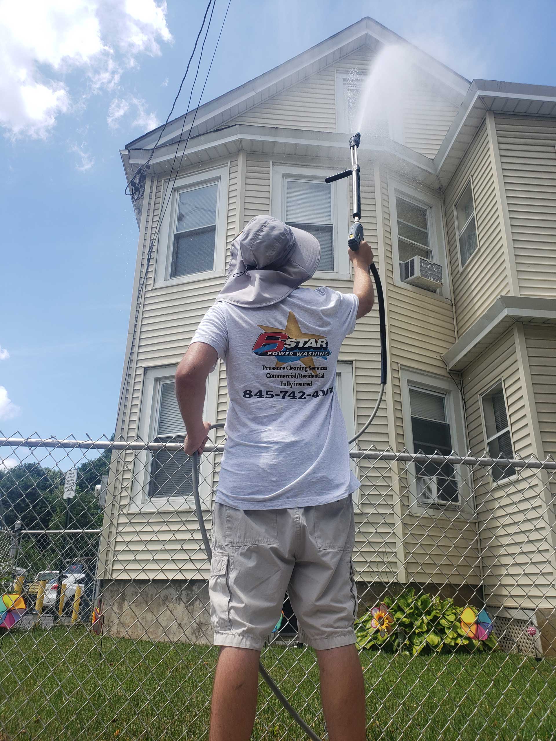 Professional Worker Cleaning Sidings — Arlington, NY — 6 Star Power Washing