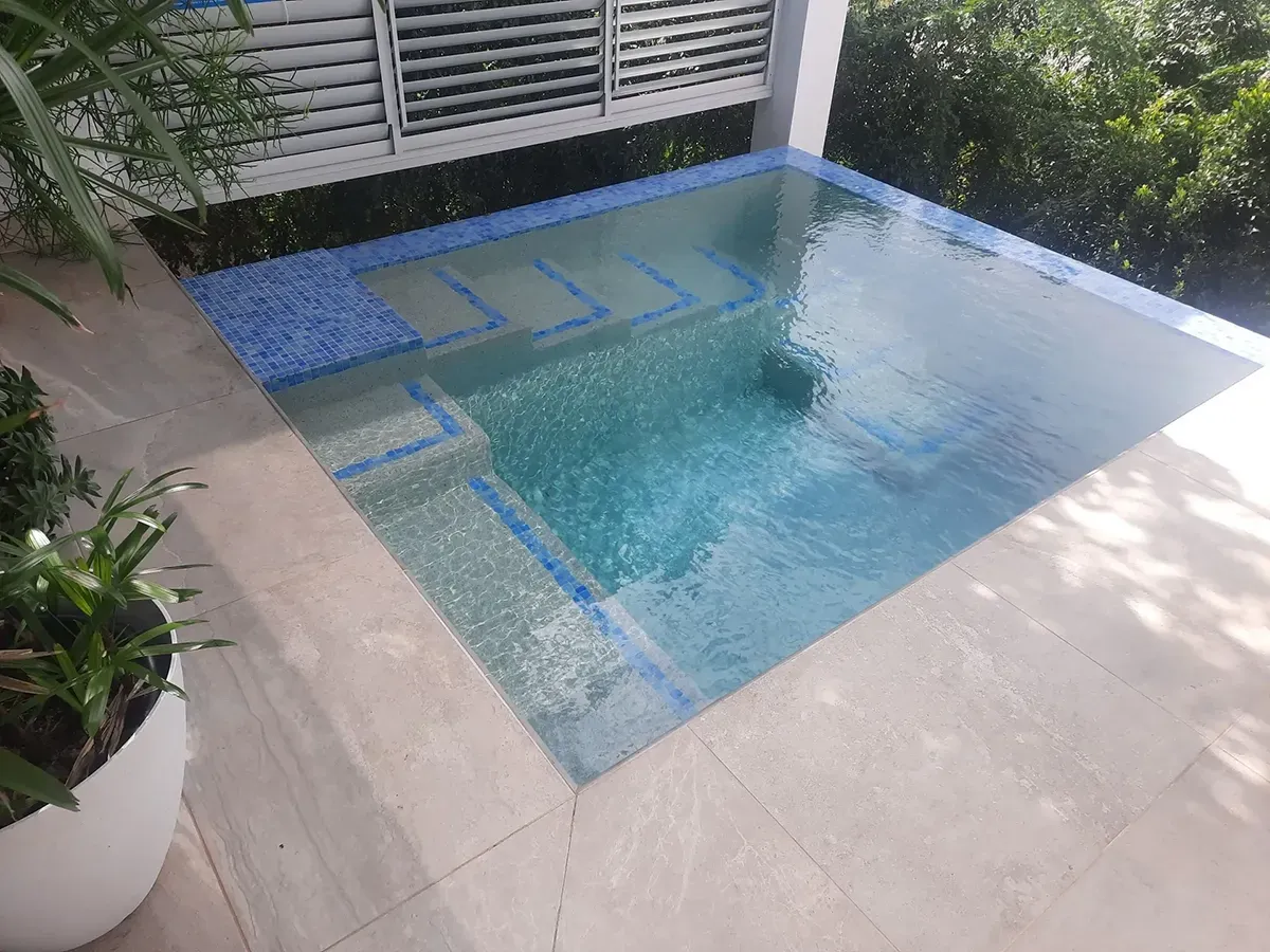 A Small Swimming Pool On Top Of A Tiled Floor — Tropical North Swimming Pools 'n' Spas In Currajong, QLD