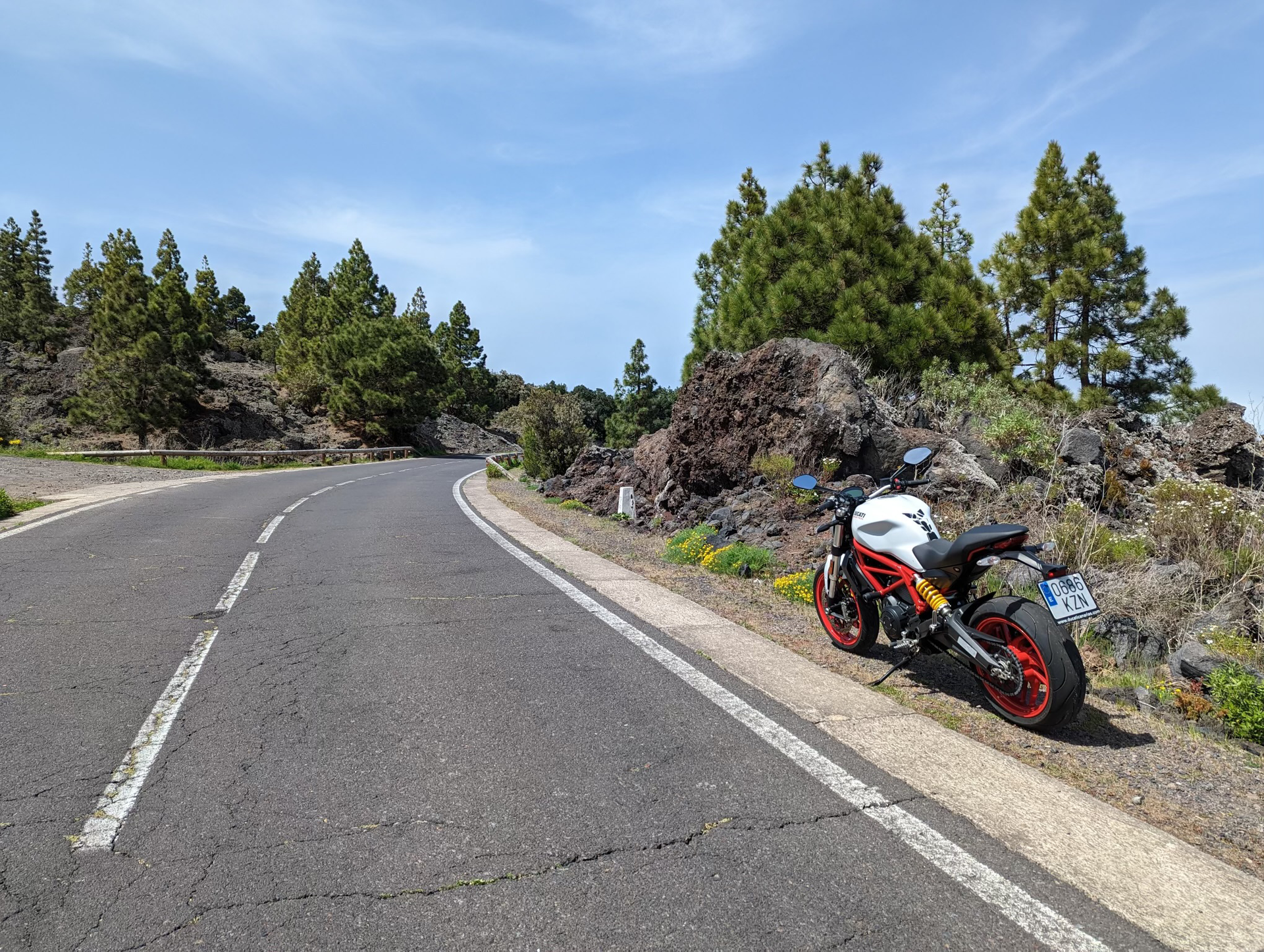 A motorcycle is parked on the side of a road.