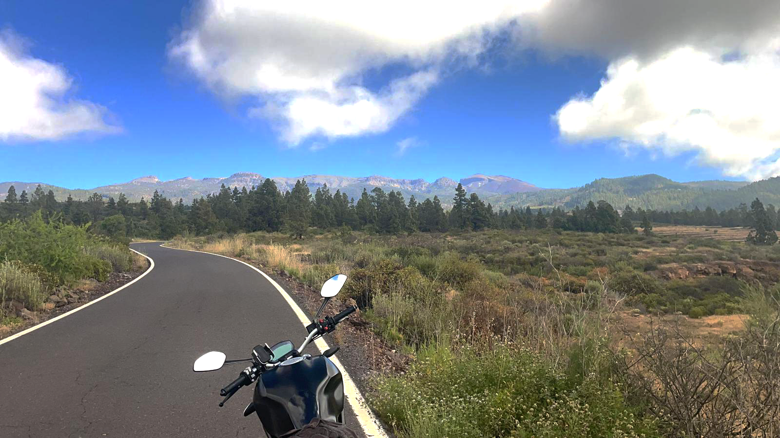A motorcycle is parked on the side of a road.