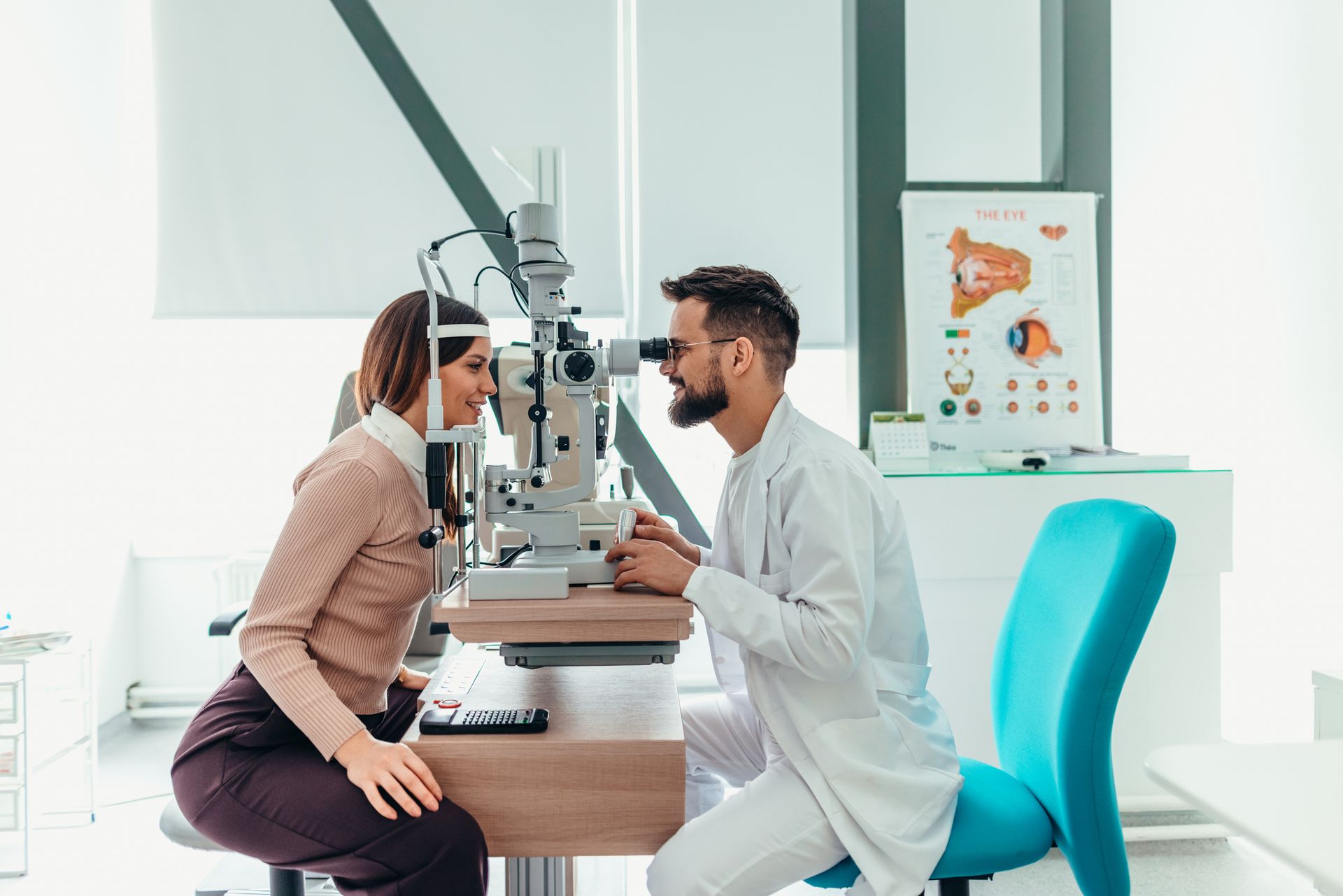 A male optometrist conducts a professional eye exam. A male optometrist conducts a professional eye exam.