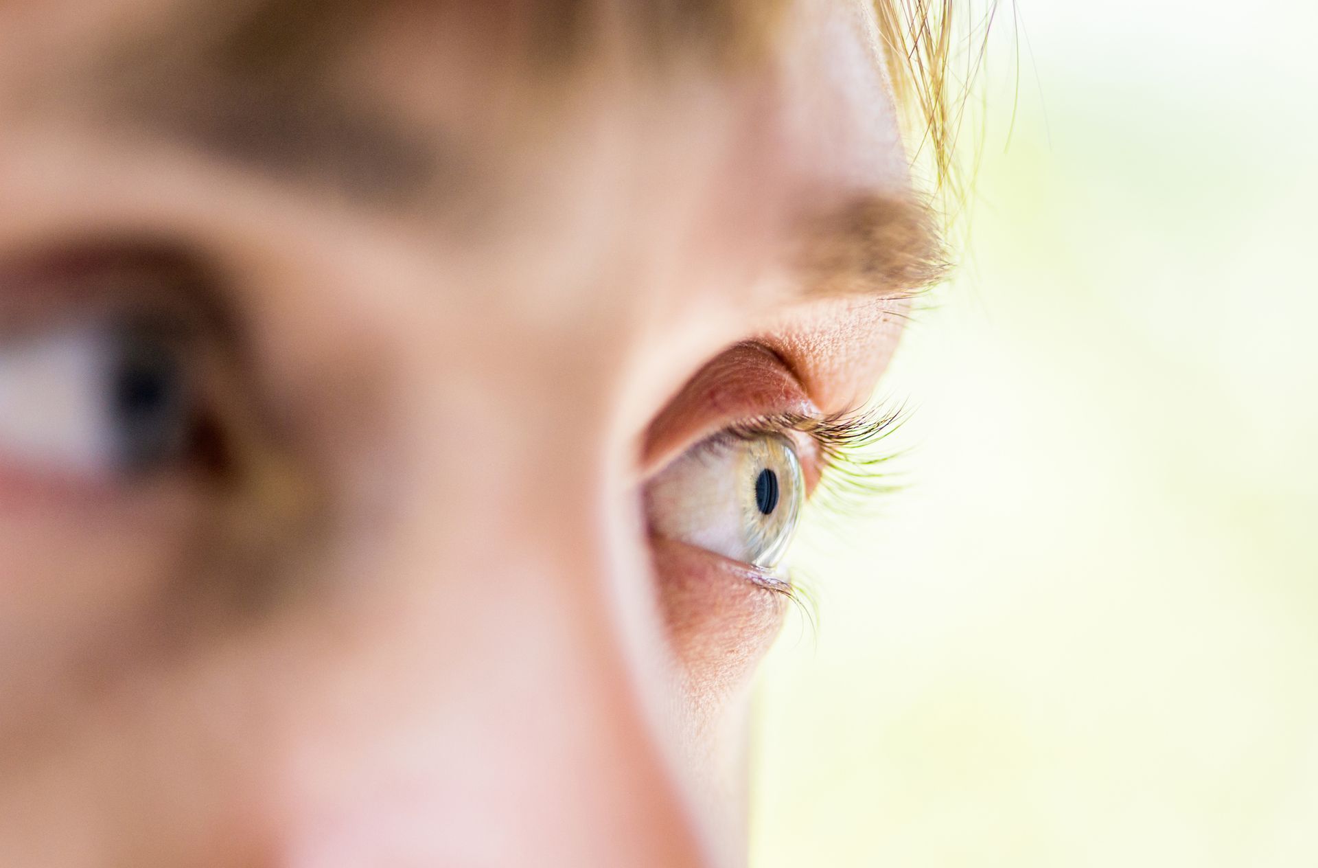 Close-up of eye with natural light and soft background for vision and eye care concept.