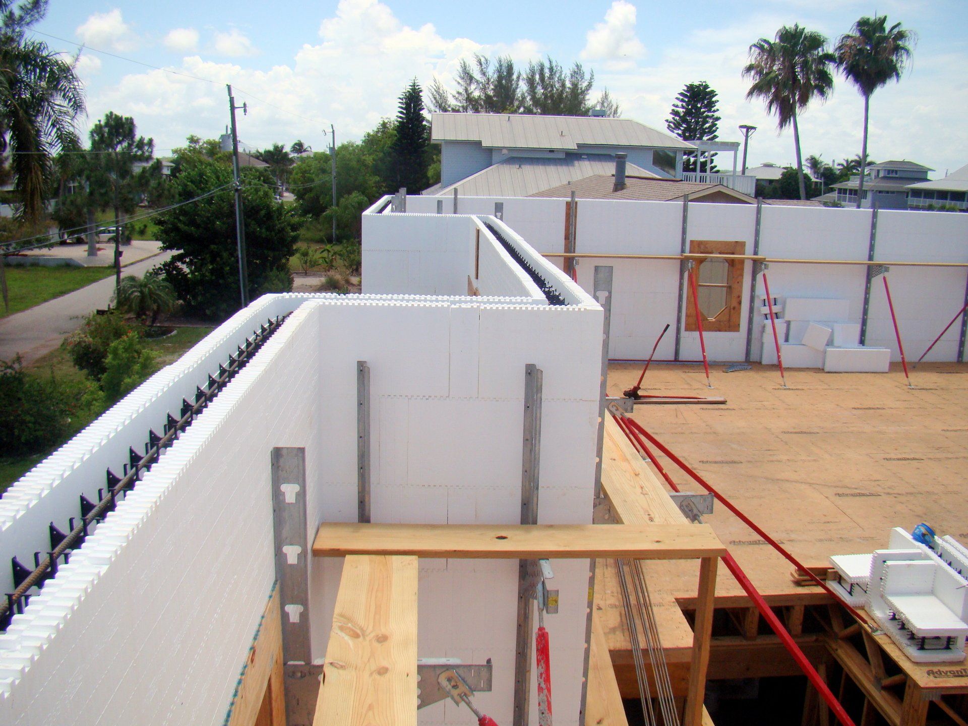 Building under construction using white insulated concrete forms, outdoor setting.