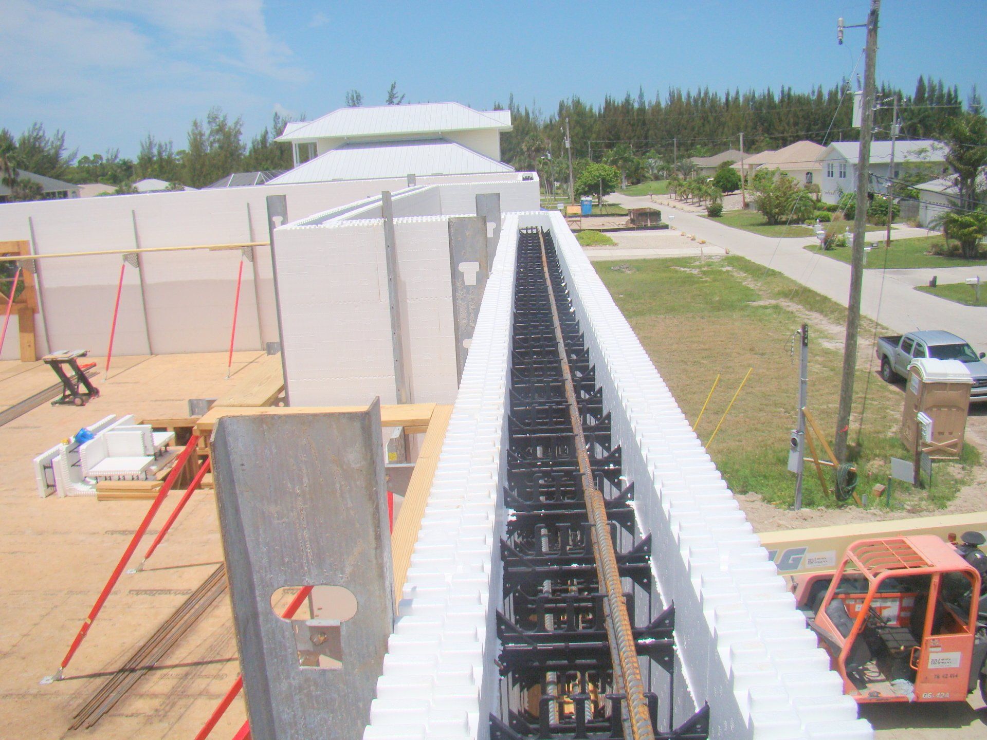 Construction site. White foam blocks form a wall around a steel structure. View from above.