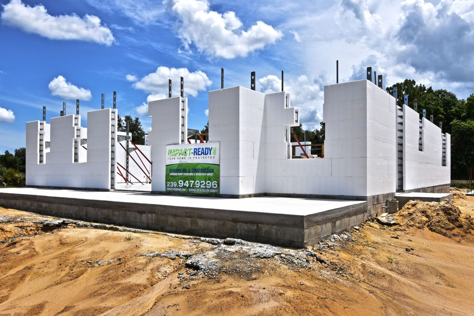 Foundation of a building under construction with white foam block walls, blue sky, sunny.