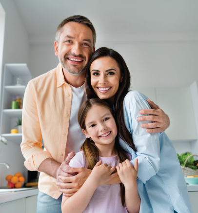 A woman is talking to a man and a woman while sitting at a table with a laptop.