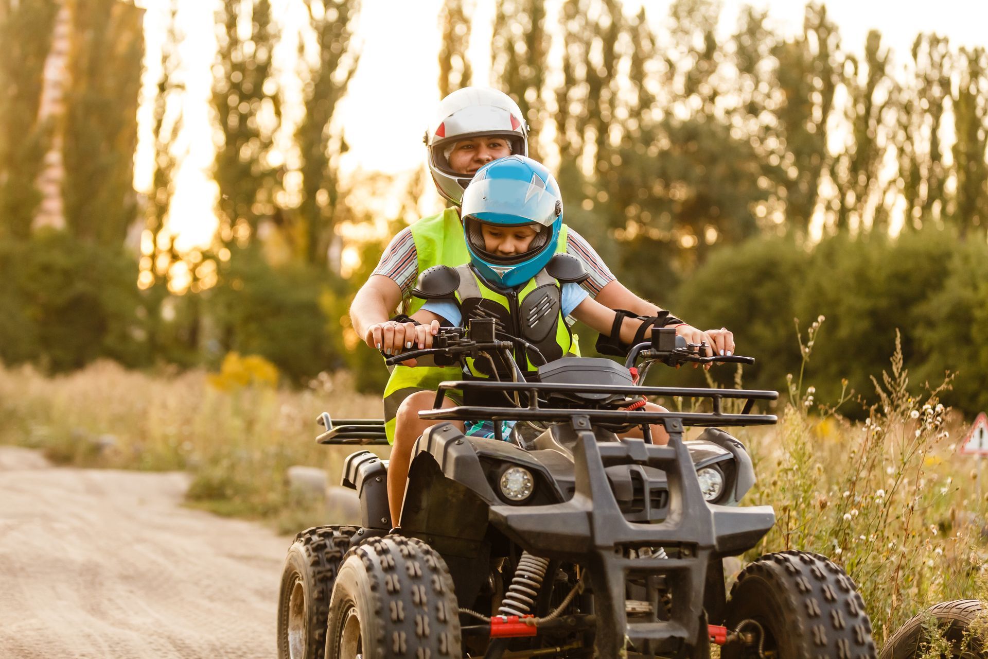 little boy with instructor on a quad bike