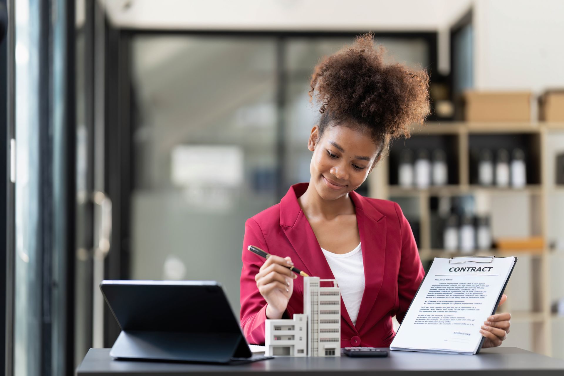 A real estate salesperson introduces the client to the model condo and inspects the lease agreement and prepares to meet with the client to sign the lease. real estate rental concept