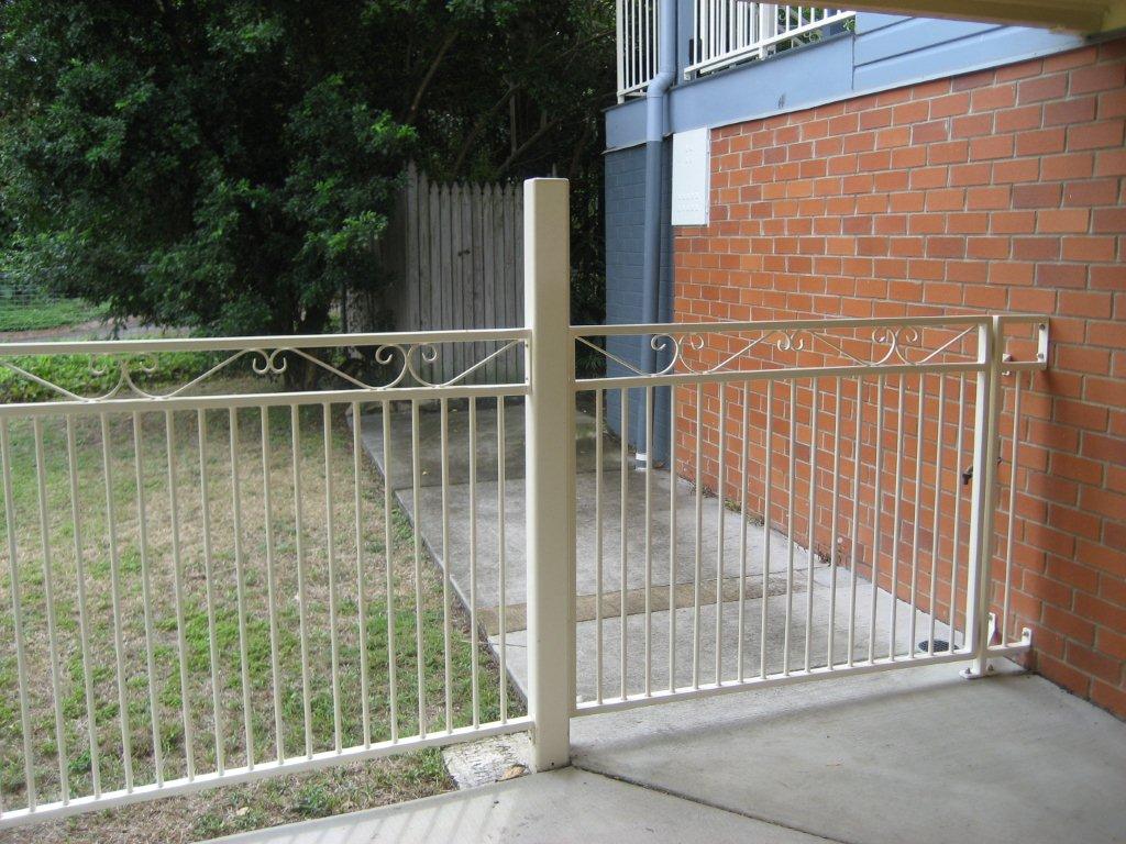 Beige Metal Fence with Side Gate — Fencing in Burleigh Heads,  QLD
