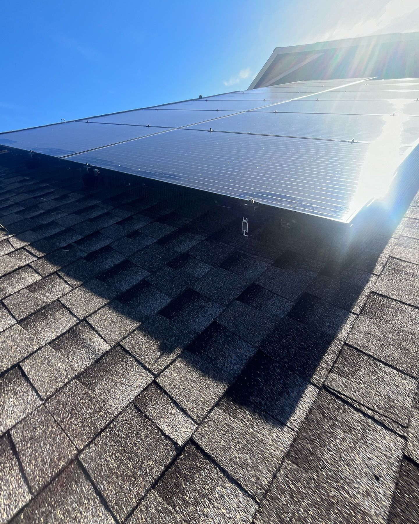 The sun is shining through the solar panels on the roof.