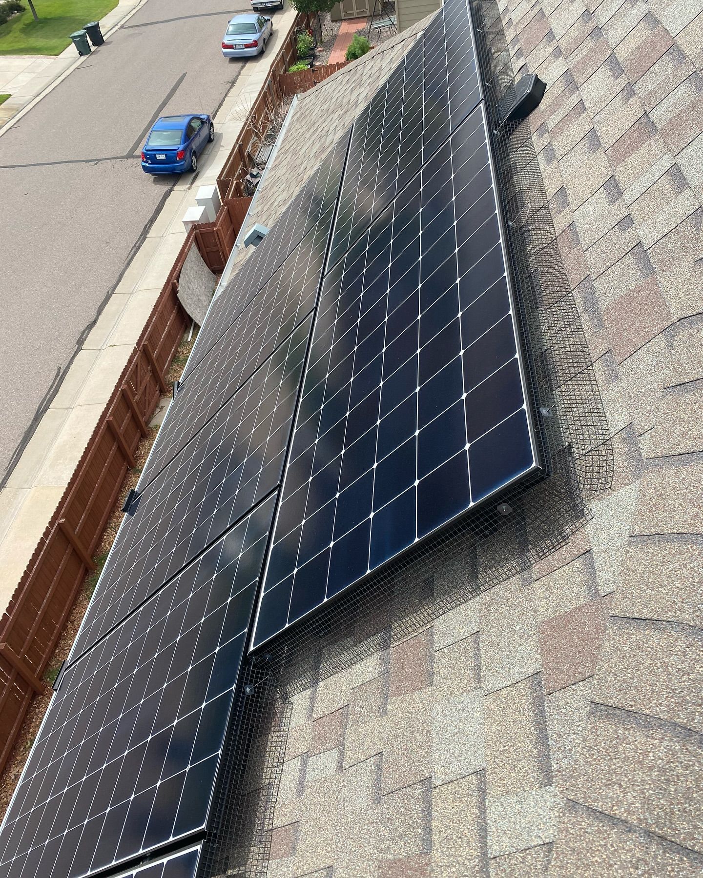 A bunch of solar panels are sitting on top of a roof.