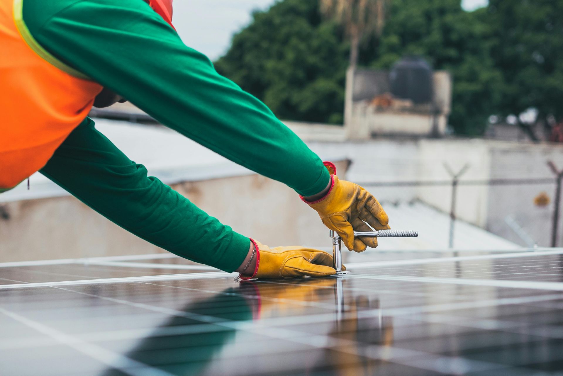 A man is working on a solar panel on a roof.