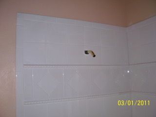 White Tiled Walls of a Shower Room