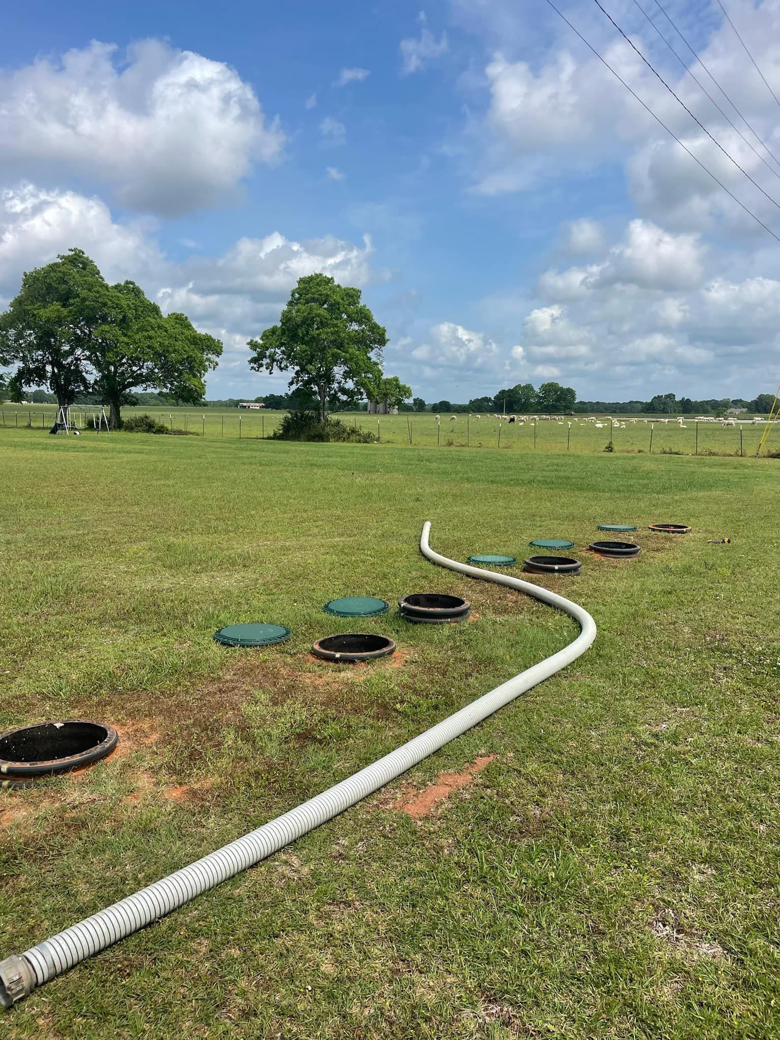 Heavy Duty Pumping | A hose is going through a grassy field.
