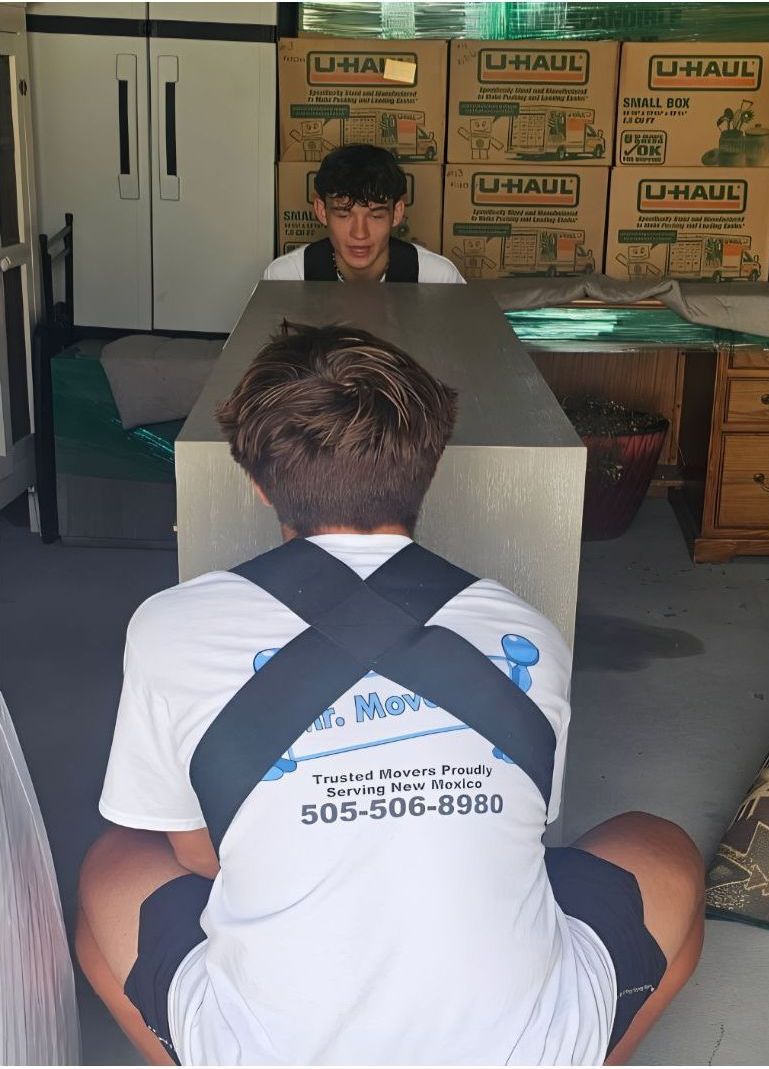 A man is taping a cardboard box with duct tape.