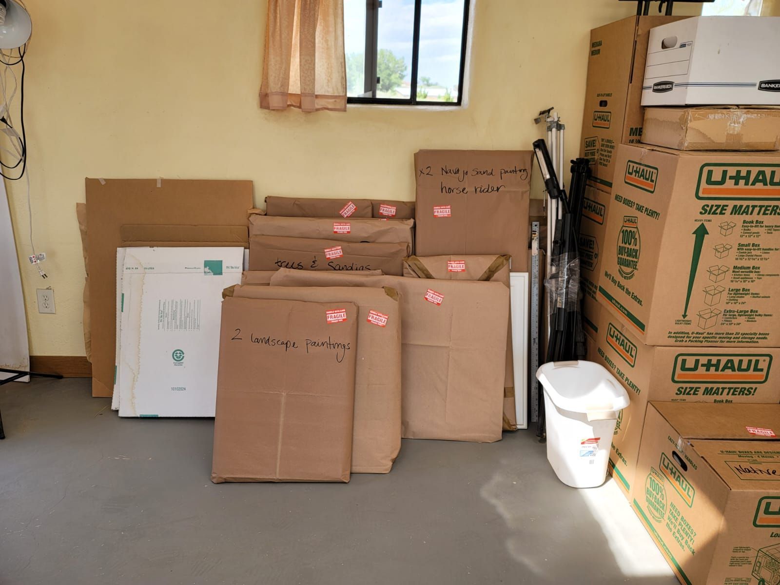 A stack of u-haul boxes in a room