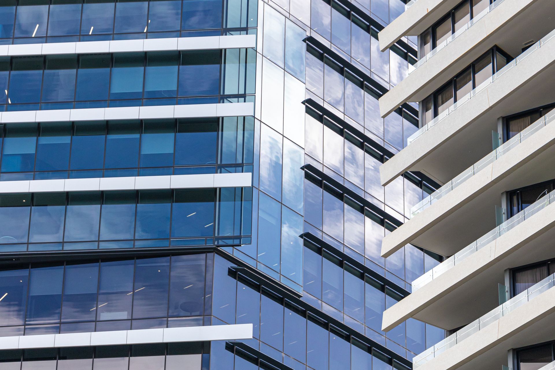 A close up of a building with a lot of windows and balconies.