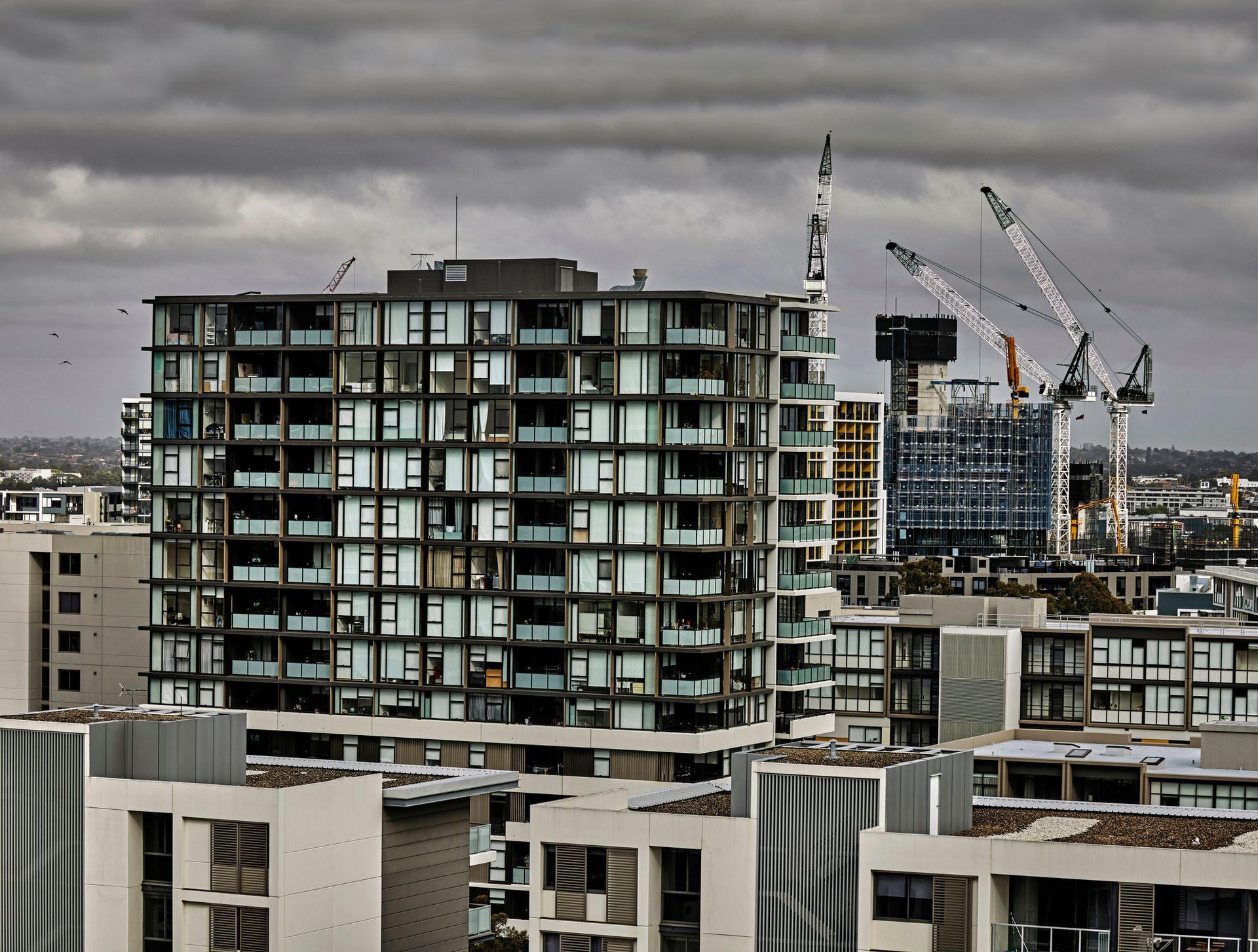 A building under construction with a cloudy sky in the background