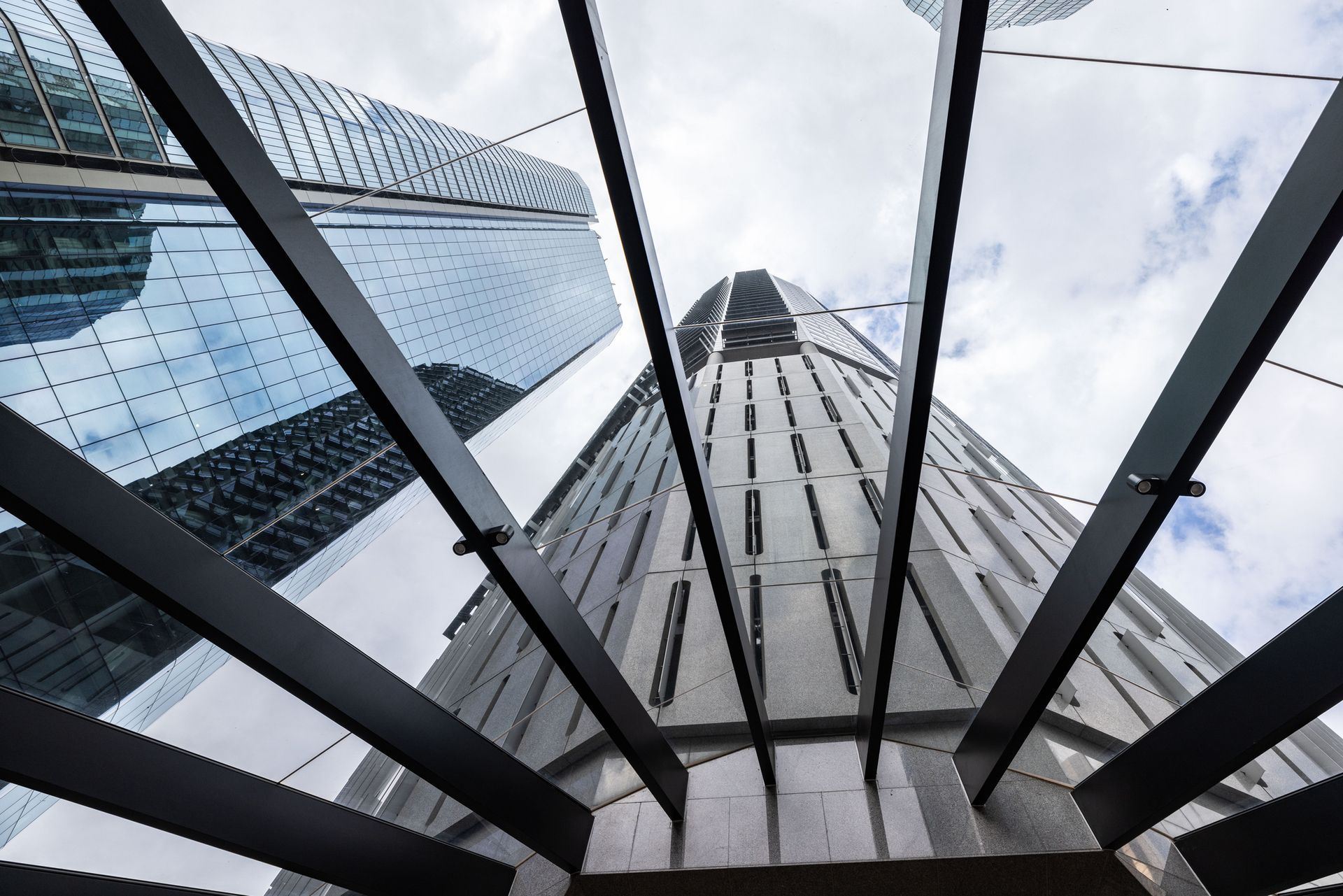 Looking up at a tall building with a glass roof.