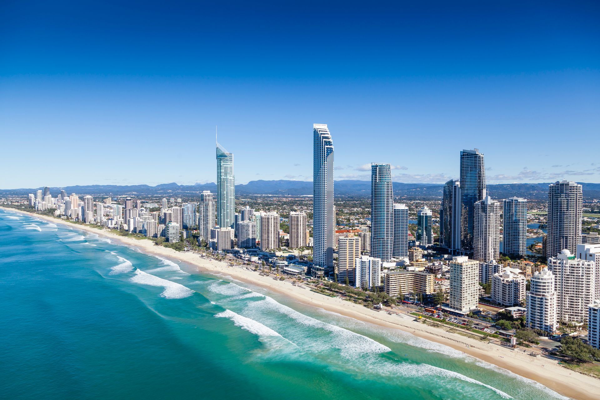 An aerial view of a city with a beach and a city skyline.