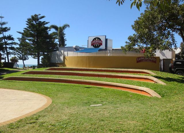 A stage in a park with a sign that says ' lions head ' on it