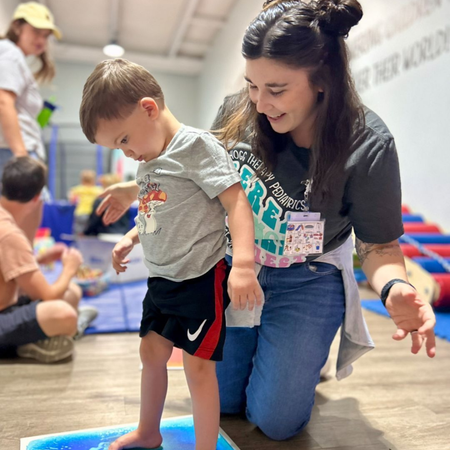 Pediatric physical therapist with child