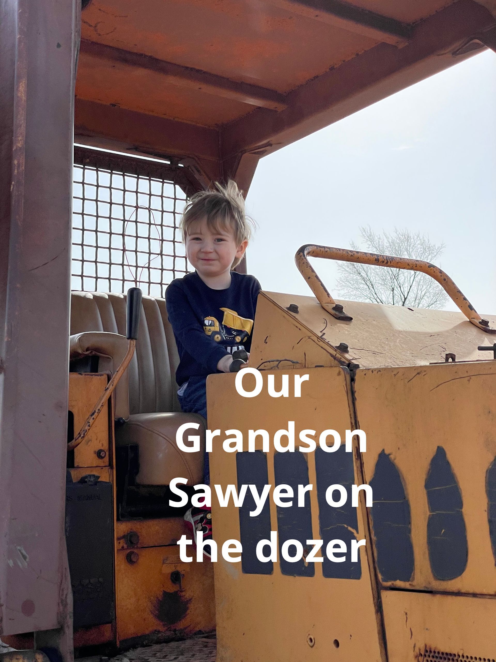 Grandson Sawyer up on the dozer