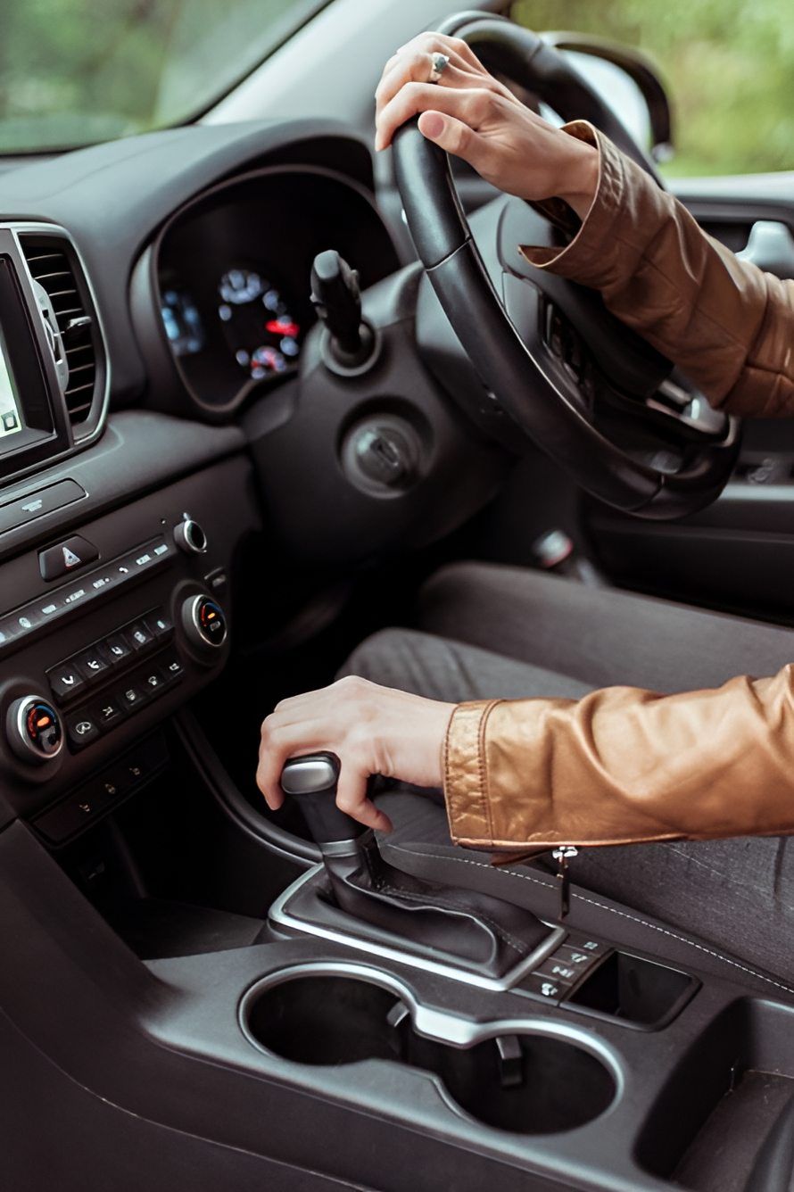 A Woman Is Driving A Car With Her Hands On The Steering Wheel — Cairns Traffic Lawyers In Cairns City, QLD