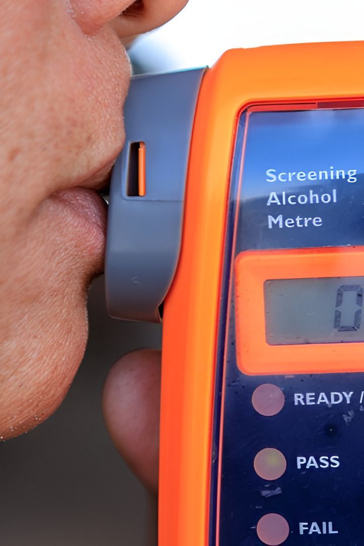A Close Up Of A Person Using An Alcohol Meter — Cairns Traffic Lawyers In Cairns City, QLD