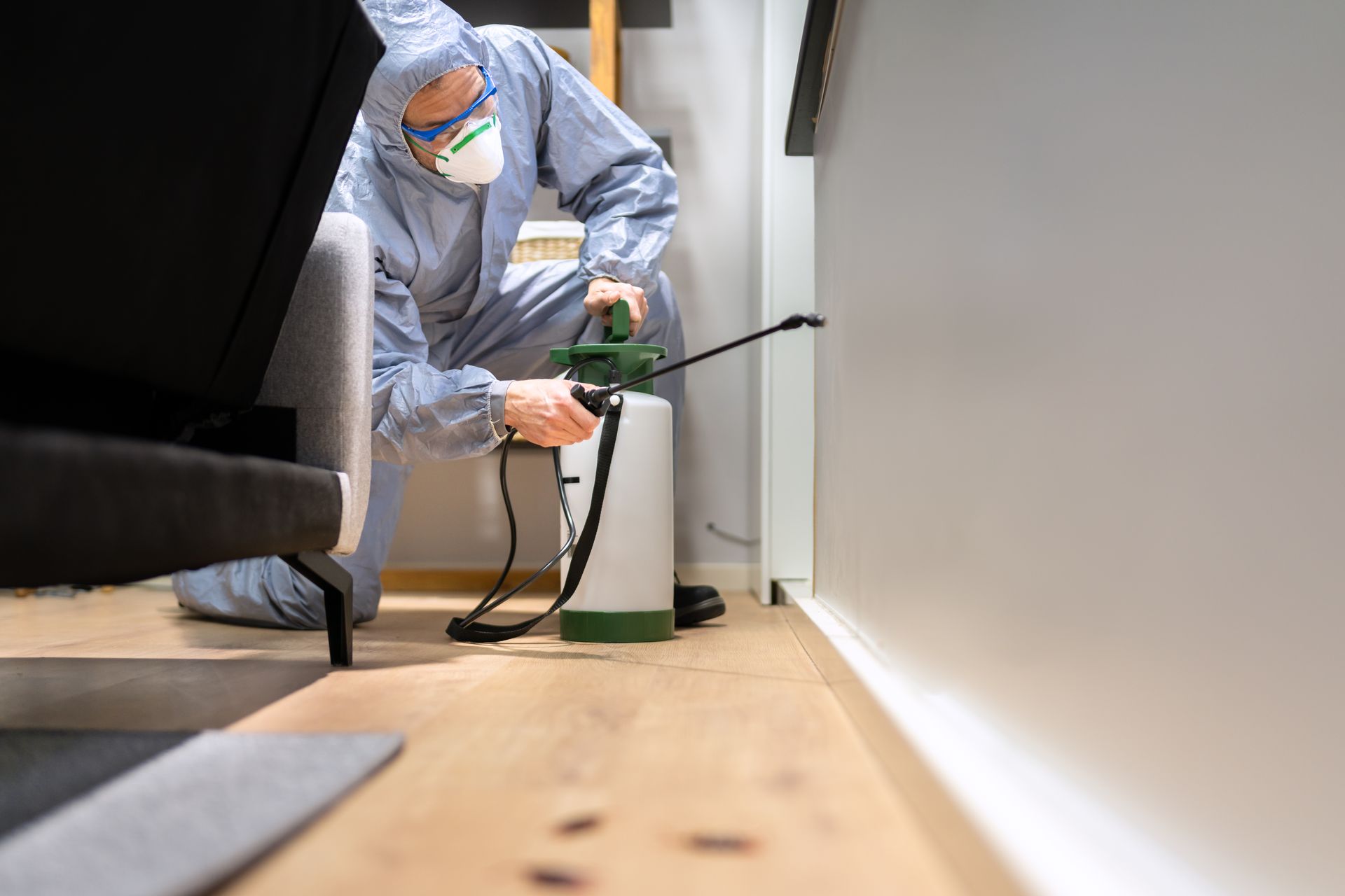 Pest control technician spraying for residential pest control services