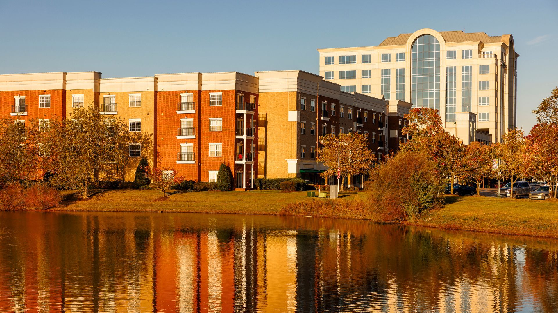 A large building is reflected in a body of water