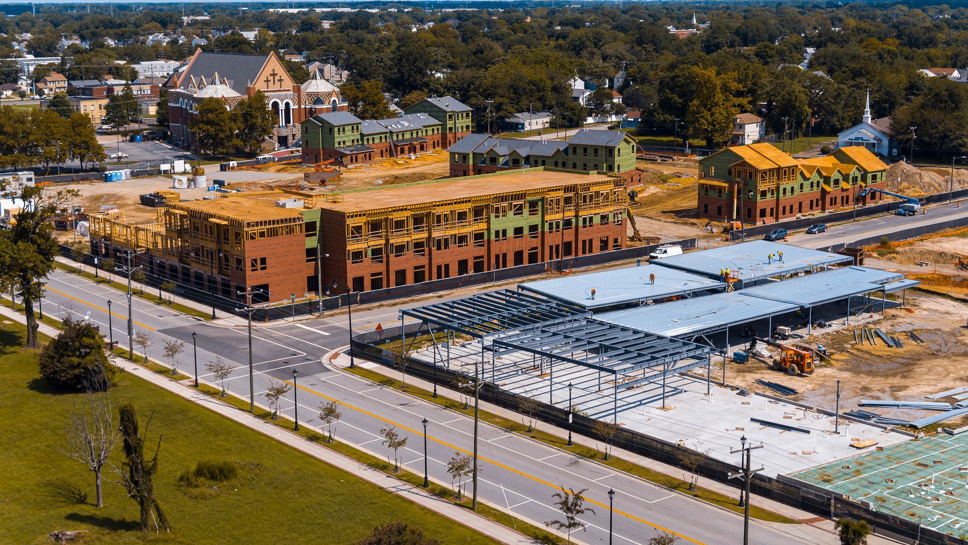 An aerial view of a building under construction in a city.