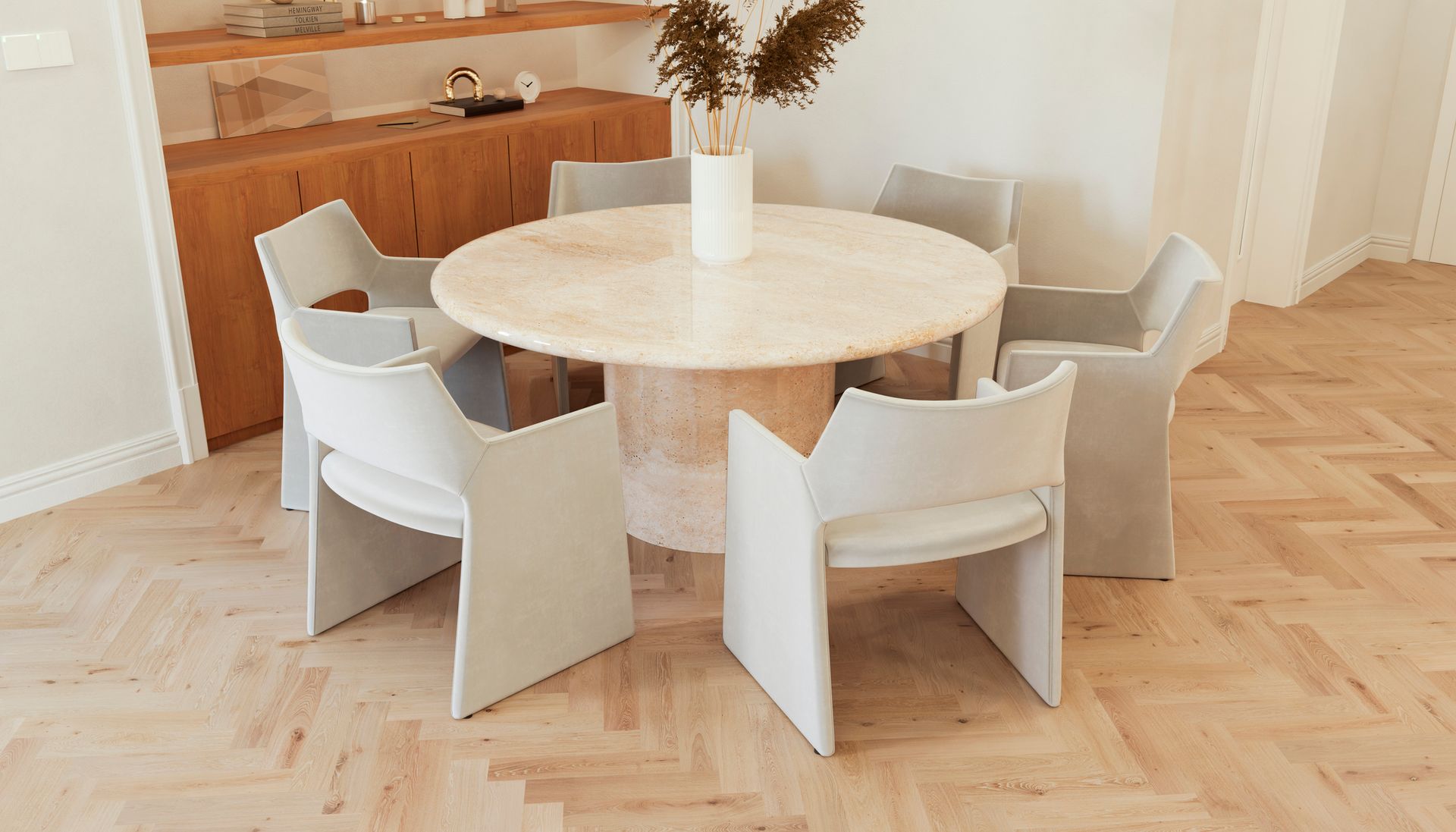 A dining room with a round table and chairs.