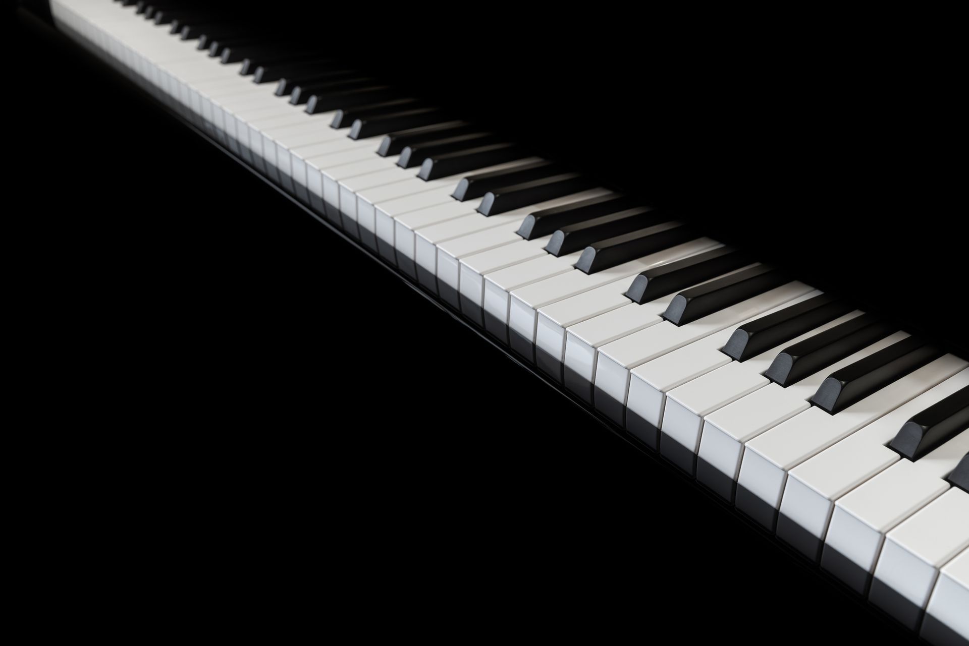 A close up of a piano keyboard on a black background