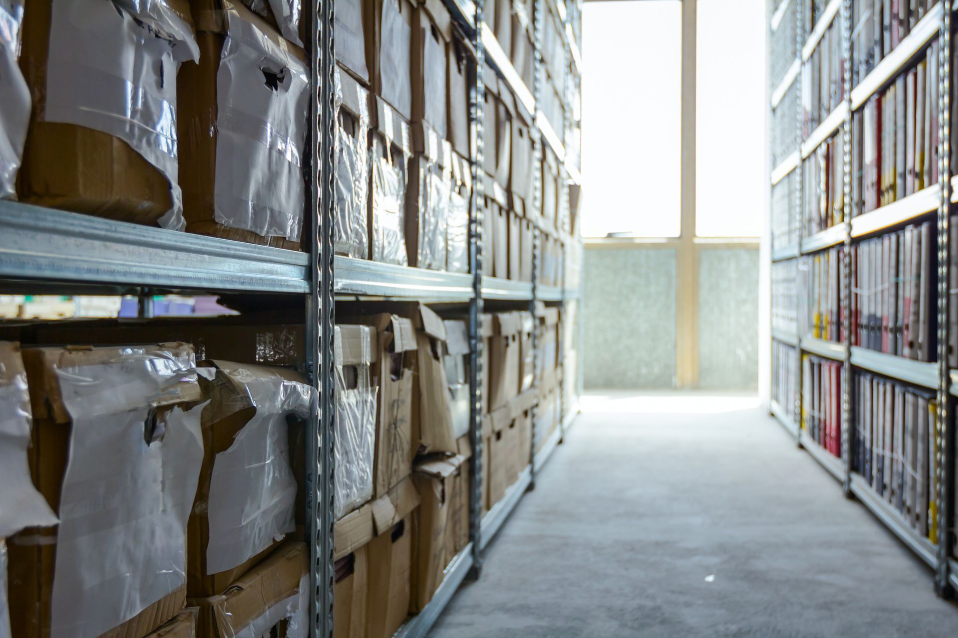 A warehouse filled with lots of boxes on shelves.