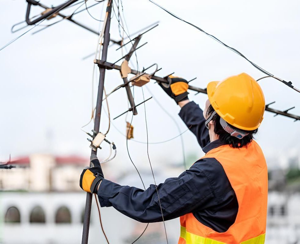 A Man is Working on an Antenna on Top of a Building — Joytech In Adelaide, SA