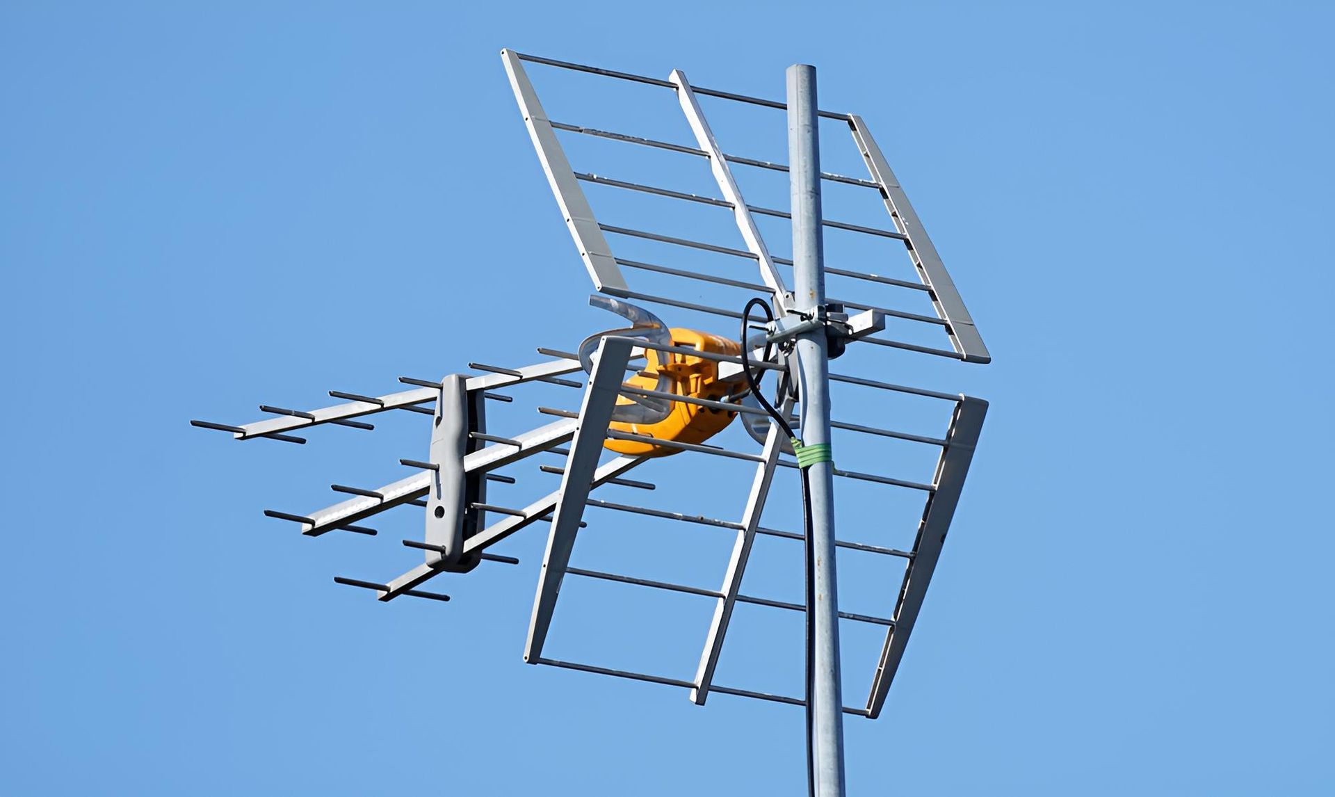 A Large Antenna is Sitting on Top of a Pole Against a Blue Sky — Joytech In Adelaide, SA
