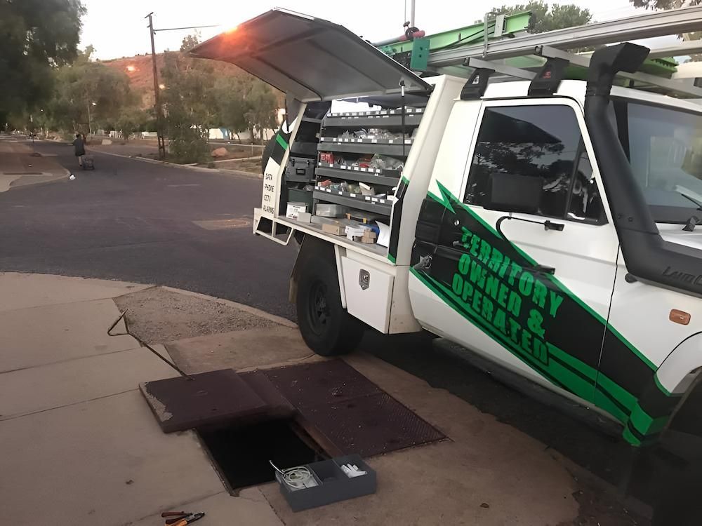 A White Truck is Parked on the Side of the Road Next to a Manhole Cover — Joytech In Adelaide, SA