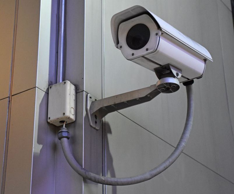 A Security Camera is Mounted on the Side of a Building — Joytech In Adelaide, SA