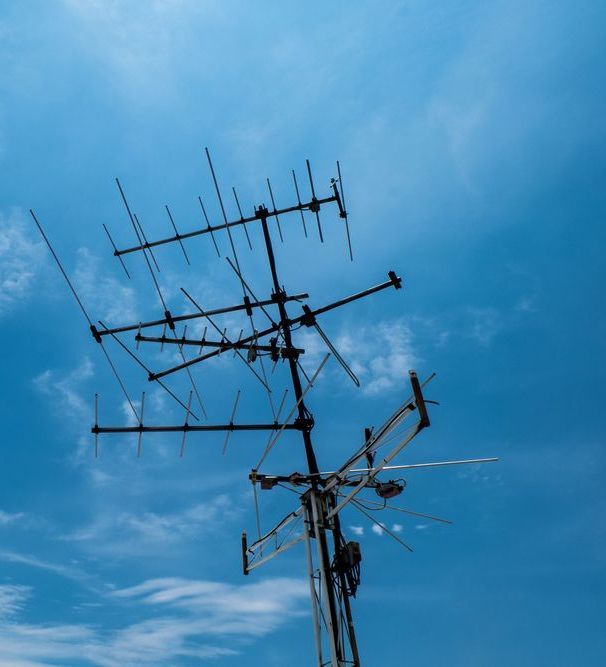 A Large Antenna Against a Blue Sky With Clouds — Joytech In Adelaide, SA